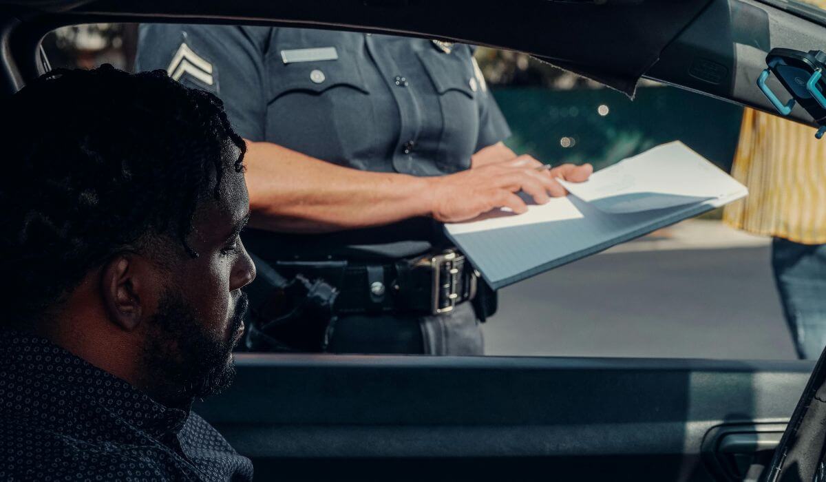 Driver stopped by police officer receiving citation, highlighting legal challenges and consequences of driving with a Suspended License.