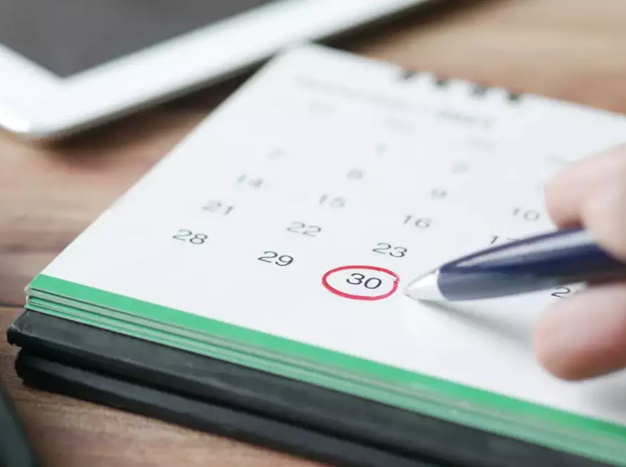 Person circling a deadline on a calendar while planning around Illinois hearing office schedules and closures.