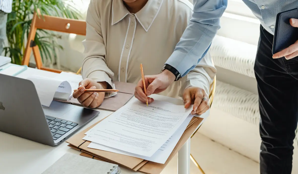 Two individuals reviewing license reinstatement vs expungement documents during an Illinois legal paperwork consultation session.