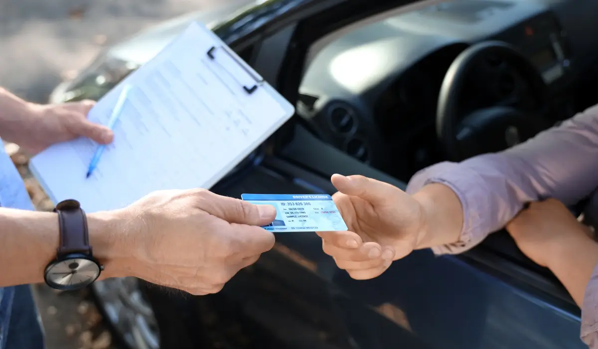 Driver presenting a license during official review, representing Regaining Independence After Revocation in Illinois through structured license restoration.